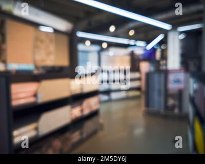 Scaffali con un'ampia selezione di sfondi nel negozio. Rotoli colorati di carta da parati come sfondo Foto Stock