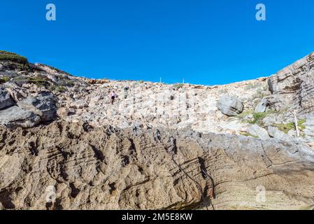 Arniston, Sud Africa - 22 settembre 2022: Persone che tornano all'area di parcheggio dalla Grotta di Waenhuiskrans vicino ad Arniston nella Provincia del Capo Occidentale Foto Stock