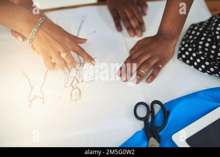 I dettagli che fanno risaltare un outfit. due progettisti che discutono di uno schizzo. Foto Stock