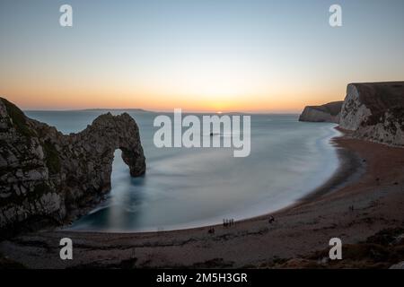 Lunga esposizione del mare calmo a Durdle Door al crepuscolo Foto Stock