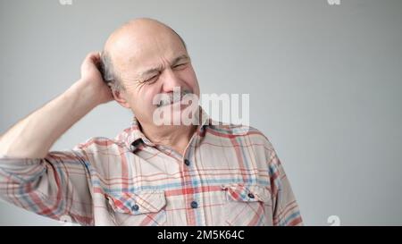 Uomo ispanico anziano che cerca di ricordare qualcosa o che ha mal di testa terribile. Foto Stock