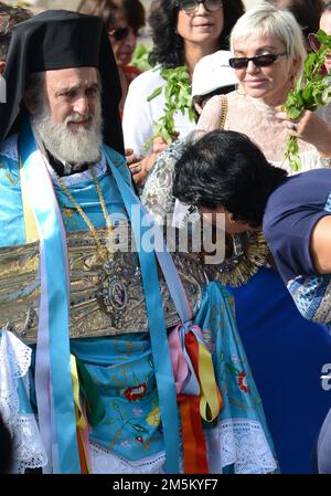 Un sacerdote greco-ortodosso che porta un'icona argentata della Vergine Maria durante una processione dalla Tomba al largo della Vergine alla chiesa del Santo Sepolcro nella città vecchia di Gerusalemme. Foto Stock