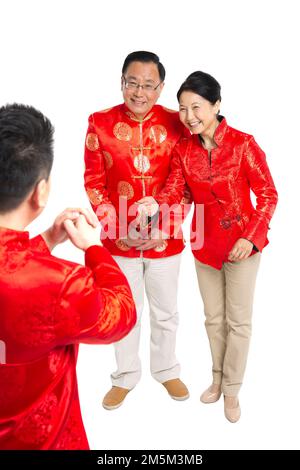 Felice famiglia di abbigliamento del Capodanno cinese Foto Stock