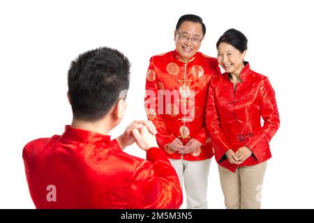 Felice famiglia di abbigliamento del Capodanno cinese Foto Stock