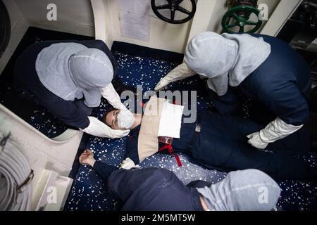 MARE DELLE FILIPPINE (27 marzo 2022) i marinai assegnati al cacciatorpediniere missilistico guidato della classe Arleigh Burke USS Dewey (DDG 105) partecipano a un'esercitazione medica del team durante la formazione tattica avanzata di Surface Warfare (SWATT). SWATT offre alla flotta opportunità di completare l'esercizio tattico necessario per aumentare la letalità e la competenza tattica. Foto Stock