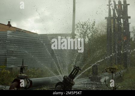 Rottura del tubo con acqua. Incidente della tubazione. L'acqua calda fluisce dai tubi. Emergenza. Foto Stock