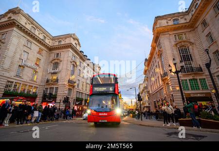 People and traffic at Piccadilly Circus in London, UK. This is an evening view south from Piccadilly Circus towards Regent Street Saint James's Stock Photo