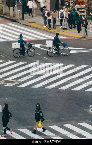 Ciclisti e pedonali che attraversano l'incrocio di Shibuya Foto Stock