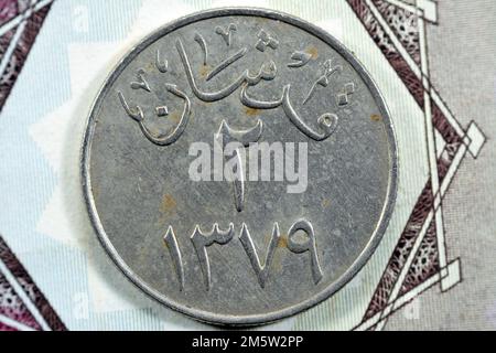 Traduzione dell'arabo (due piaster 1379) dal lato opposto di una vecchia Arabia Saudita una piastre 10 dieci moneta Halalah, vintage retro vecchio denaro Saudita c Foto Stock