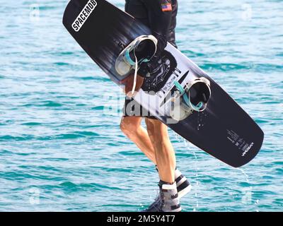 Il wakeboarder uomo porta la sua tavola Foto Stock