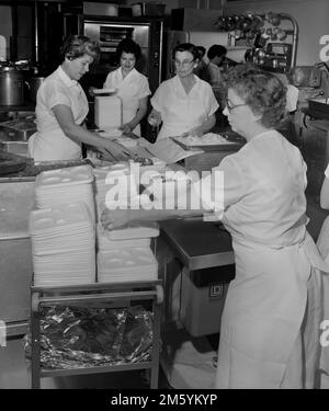 Pranzo le Signore preparano i pranzi in una caffetteria della scuola in California, ca. 1961. Foto Stock