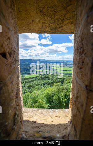 vista incorniciata attraverso la finestra del vecchio castello di pietra sulla campagna tedesca Foto Stock