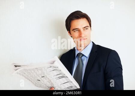 Giovane uomo d'affari che legge un giornale con copyspace. Ritratto di un giovane uomo d'affari che legge un giornale con copyspace. Foto Stock