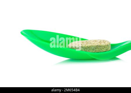 cucchiaio di plastica verde con aglio supplementare isolato su fondo bianco. Foto Stock