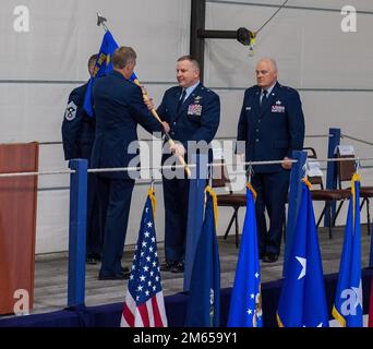 Douglas A. Farnham, l'Adjutante Generale del Maine, di sinistra, presenta al suo nuovo comandante, Brig, la guida organizzativa della Guardia Nazionale aerea del Maine. Gen. Frank W. Roy, al centro, mentre Brig. Il generale Steven D. Michaud, comandante uscente, è in piedi dopo aver completato il suo comando durante una cerimonia di cambio di comando alla 101st Air Refueling Wing a Bangor il 3 aprile 2022. (Maine Air National Guard foto di Sr. Airman Erick Green) Foto Stock