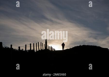 Donna che cammina sul sentiero costiero vicino a Borth e Aberystwyth, Ceredigion, Galles, Regno Unito Foto Stock