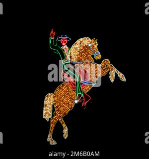 Segno colorato al neon, luci al neon nella forma notturna cavallo e cavaliere onde, cavalli sorge, Bokeh, Fremont Street, Las Vegas, Nevada, Stati Uniti Foto Stock