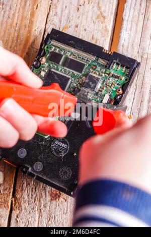 Un uomo rompe un computer utilizzando attrezzi fabbro. Foto Stock