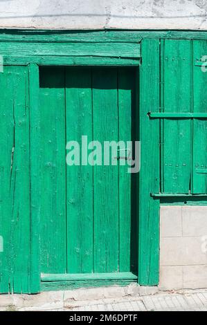 Vecchia casa rurale verde stagionato in legno porta di primo piano Foto Stock