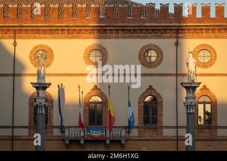 Il municipio di Ravenna dal balcone sono esposte 4 bandiere, europee, italiane, regionali e una bandiera della città, due staue di Sant'apollinare e Vitalis Foto Stock