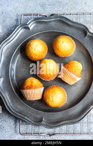 Mini cupcake alla vaniglia su sfondo di cemento Foto Stock