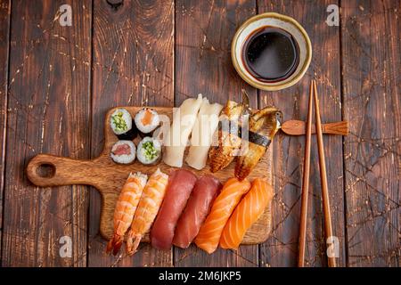 Sushi set. Diversi tipi di rotoli di sushi su legno scheda servente Foto Stock