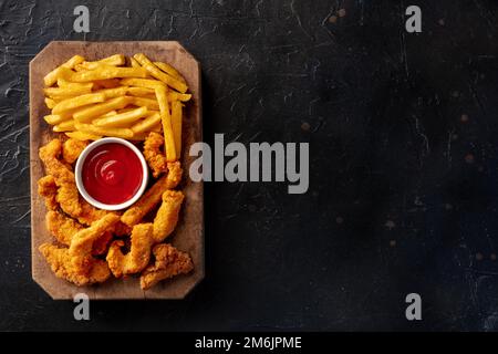 Pollini, pepite impanate, con un tuffo al barbecue e patatine fritte Foto Stock