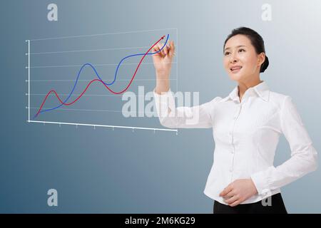 Le giovani donne di affari disegnano il grafico della curva Foto Stock