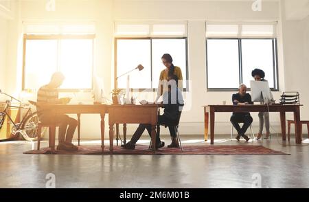 La creatività cresce in questo ufficio. un gruppo di designer che lavorano in un ufficio moderno. Foto Stock