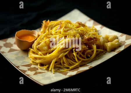 Spaghetti Carbonara è un piatto italiano di pasta di Roma fatto con uova, formaggi stagionati, maiale stagionato e pepe nero. Foto Stock