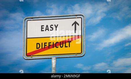 Un cartello stradale di facile versus difficile Foto Stock