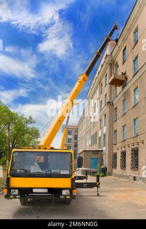 Gru mobile Big Power su una gru a torre e su strada in cantiere Foto Stock