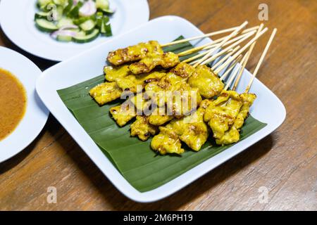 Il satay di maiale è popolare cibo di strada in Thailandia. Foto Stock