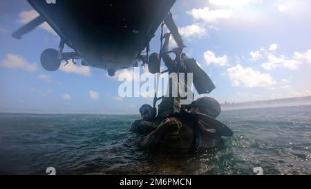 Un berretto verde con 2nd battaglione, 10th Special Forces Group (Airborne), sale una scala fissata ad un elicottero UH-60 Black Hawk che si affaccia sul Golfo del Messico vicino Key West, Florida, 3 maggio 2022. L'Helocasting, o free-drop da un elicottero, è stato condotto per familiarizzare il personale delle forze operative speciali con le tecniche di inserimento ed estrazione in un ambiente di acqua spesso usato in aree semi- o non-permissive per rimanere clandestino. (Foto DOD) Foto Stock