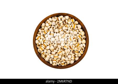 Vista dall'alto o piatto di miglio crudo fresco o sorgo in ciotola di legno. Foto Stock