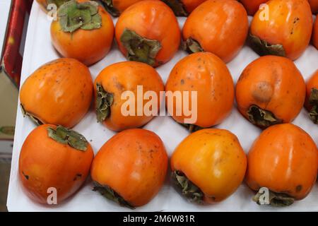 Persimmons rosso coreano fresco e maturo in set regalo Foto Stock