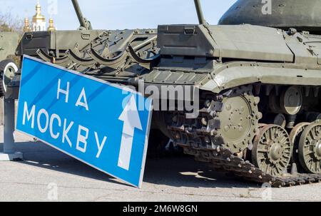 Cartello stradale blu con lettere bianche vicino al carro armato, sul territorio del Museo Nazionale di Storia dell'Ucraina. La guerra della Russia Foto Stock