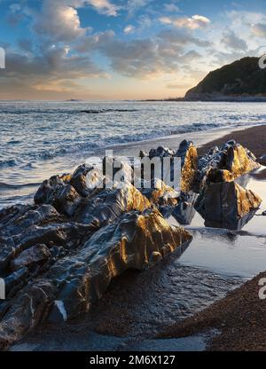 Tramonto sulla costa dell'oceano vista dalla spiaggia (vicino a Saint-Jean-de-Luz, Francia, nel golfo di Biscaglia). Foto Stock