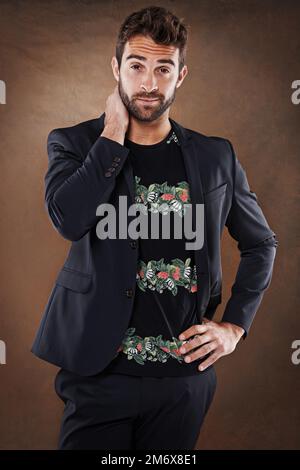 Rappresenta il perfetto esempio di eleganza moderna. Studio di un giovane vestito elegantemente. Foto Stock