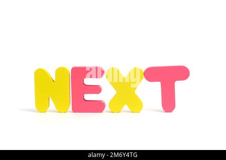 Word NEXT composto lettere multicolore sfondo bianco Foto Stock