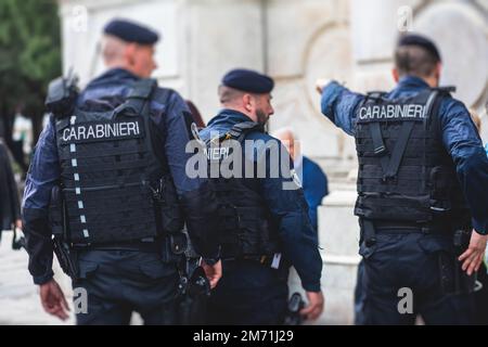 Carabinieri italiani, gendarmerie nazionali d'Italia, di Italia formazione di pattuglia vista posteriore con logo 'Carabiner' emblema su uniforme mantenere publicite Foto Stock