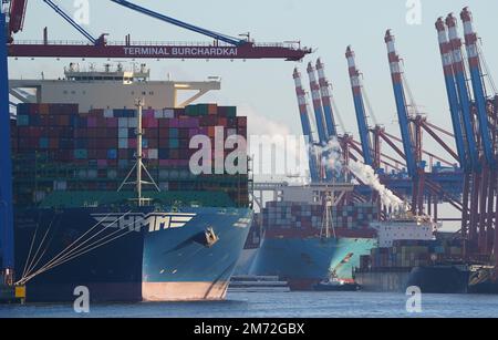 PRODUZIONE - 03 gennaio 2023, Amburgo: Le navi portacontainer vengono caricate e scaricate presso il terminal dei container Burchardkai (l) e il terminal dei container Eurogate (posteriore r) nel porto. Il porto di Amburgo sull'Elba è un porto universale per tutti i tipi di merci e di gran lunga il più importante luogo di movimentazione merci in Germania. Ogni anno, circa 130 milioni di tonnellate di merci di mare passano oltre i bordi del molo attraverso un buon 50 impianti di movimentazione, e circa 290 ormeggi offrono spazio per navi di tutte le dimensioni - da contenitori particolarmente grandi e navi portarinfuse, da petroliere e petroliere chimiche a navi di alimentazione e interne. (da a d Foto Stock