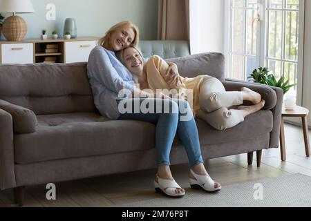Felice mamma matura e figlia abbracciando a casa con amore Foto Stock