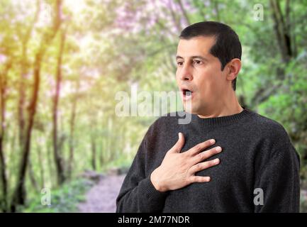 Uomo che soffre problemi respiratori in natura Foto Stock