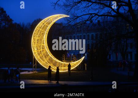 Riga, Lettonia, 1 gennaio 2023: Illuminazione a forma di luna nella città come decorazione di Capodanno Foto Stock