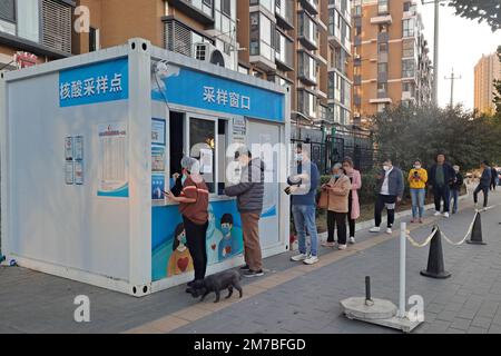 I residenti in coda per i test degli acidi nucleici su una strada sotto la politica cinese di zero covid a Pechino Foto Stock