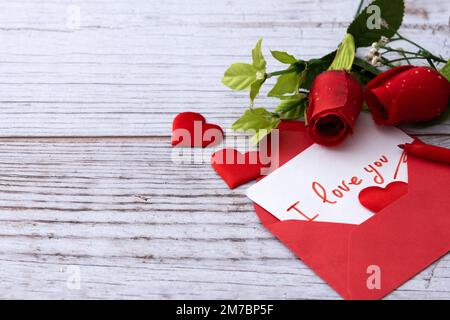 Set scatole a forma di cuore decorate con cuori rosa e rosso su sfondo rosso Foto Stock