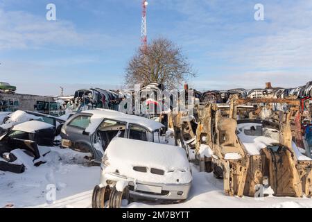 Le auto smontate su un autolavamento sono in vendita per i pezzi di ricambio. Una pila di parasoli e paraurti. Il commercio di parti di ricambio usate è un commercio comune nello sviluppo Foto Stock