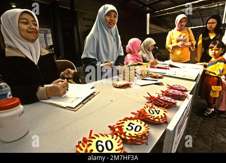 Le donne stanno preparando un concorso di colorazione per bambini nella zona di Gegerkalong, centro delle attività di Daarut Tauhiid, un'istituzione islamica fondata dal famoso predicatore islamico indonesiano, KH Abdullah Gymnastiar, situato a Bandung, Giava Occidentale, Indonesia. Gymnastiar (popolarmente noto come AA Gym), Daarut Tauhiid, e il loro ramo di gestione Manajemen Qolbu (mq), sono riusciti a intensificare il turismo religioso e le attività economiche nella zona di Gegerkalong a Bandung City. Foto Stock