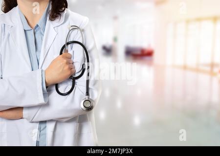 Ripresa ritagliata di un medico irriconoscibile che tiene lo stetoscopio in ospedale Foto Stock